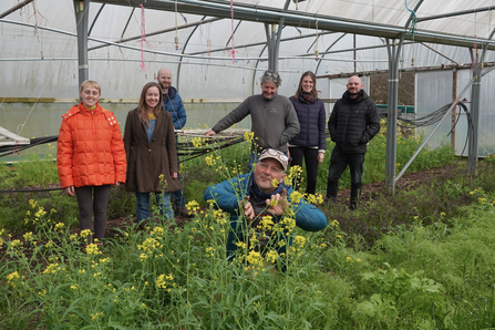 A team photo of the Spring 2023 Grow Leader participants, stood together in a polytunnel