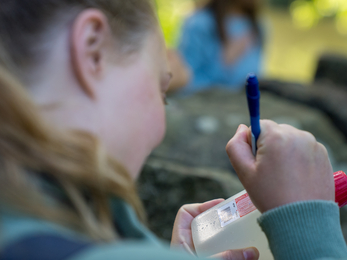 Volunteer water testing writing on sample test water