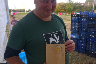 Shaun Waycott, Wildflower Nursery Manager at Grow Wilder, with the team's Bee Bold Award