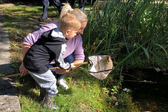 Adult and child pond dipping