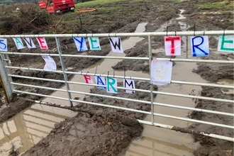 'Save Yew Tree Farm' Written on a gate