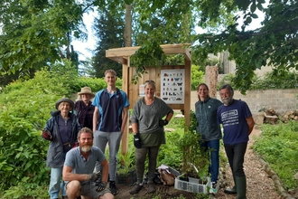 A group of people standing in front of an information board