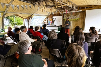 Lots of people at an event at Grow Wilder nature reserve, listening to to a young person