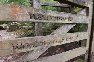 Gate inscribed with Welcome to Weston Big Wood