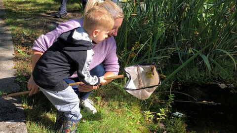 Adult and child pond dipping