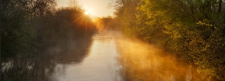 Sunrise over a misty River