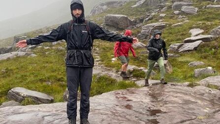 Harry stands on a rock in waterproof clothing