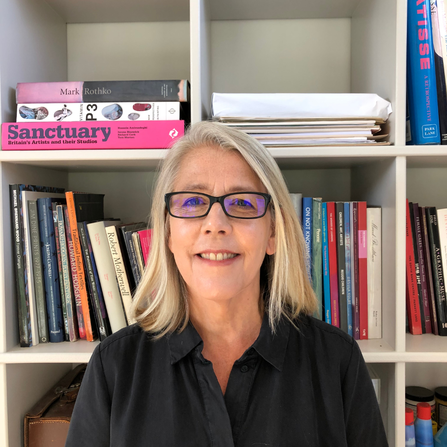 Dr Penny Hay headshot in front of bookcase