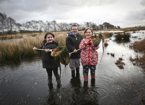 Children use nets in water