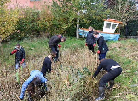 Young people working on Aardman pond