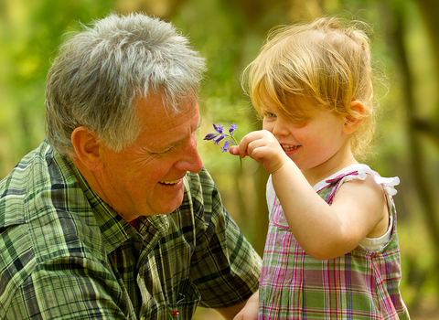 A grandfather and granddaughter with a bluebell