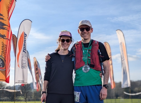 A couple standing at the finish line of a race