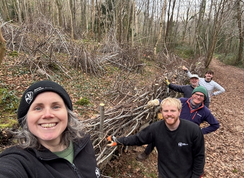 Volunteers and staff coppicing 