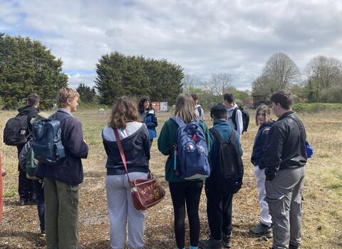 Young people standing in a circle talking at Green Shoots