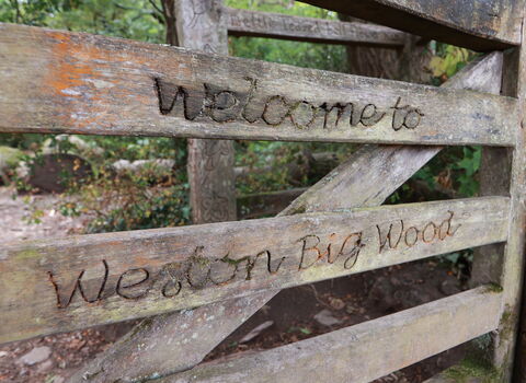 Gate inscribed with Welcome to Weston Big Wood